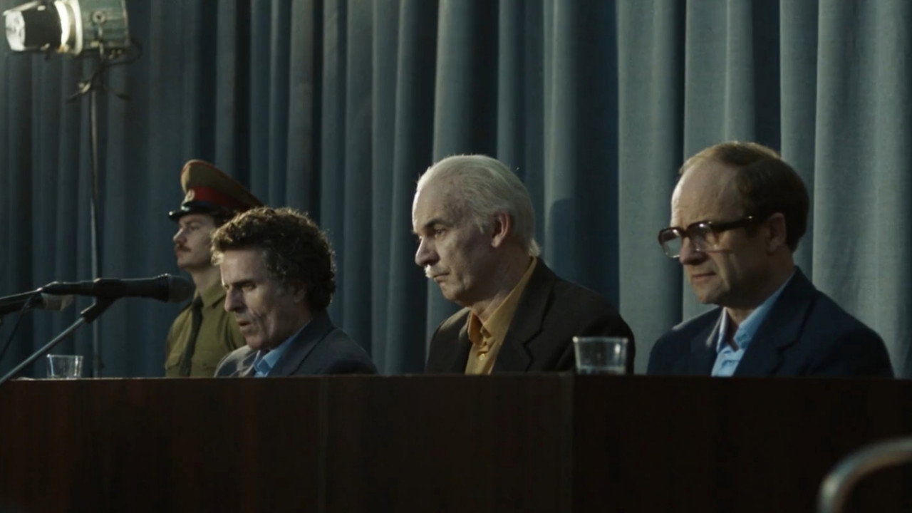 Three men seated at a courtroom hearing table, Chernobyl (2019)