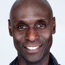 Lance Reddick als Hotel Manager / Charon