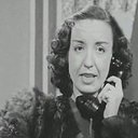 Gina als إحدى الراقصات