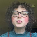 Ainsley Feeney als Ainsley, Debate Moderator