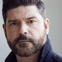 John T. Woods als Officer Outside House (voice)