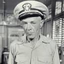 Russ Brown als Capt. J.M. Brackett, USN
