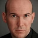 Alex MacQueen als Minister