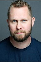 James Lewis as Shooting Stall Owner