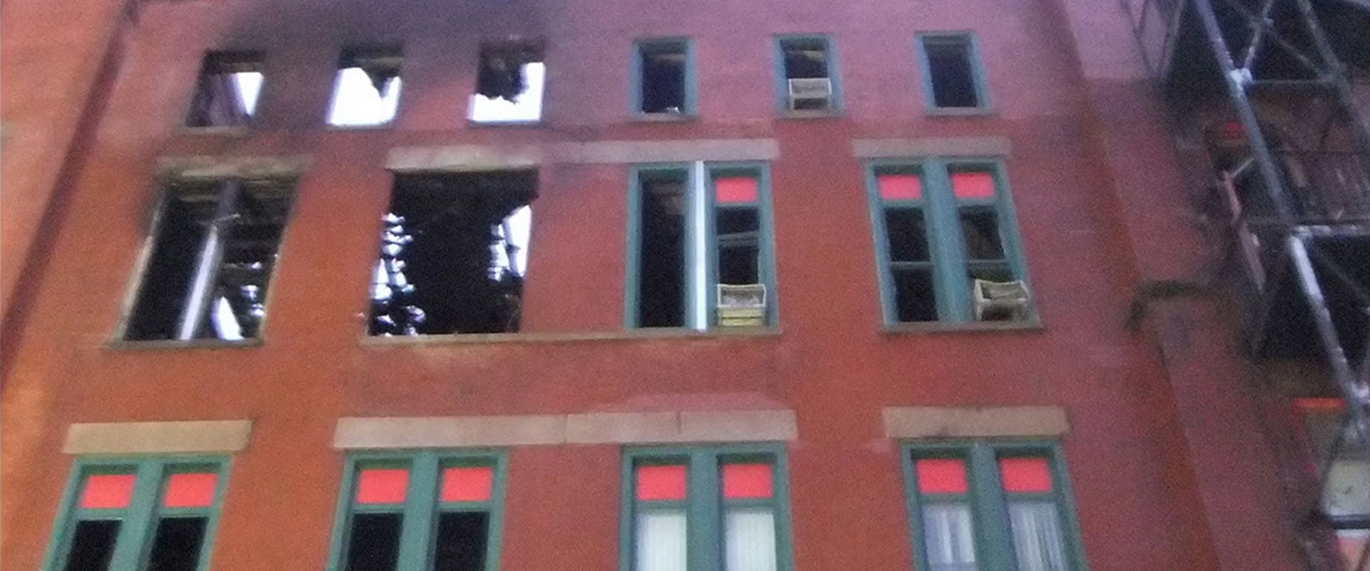 Brick Building with Red and Green Windows
