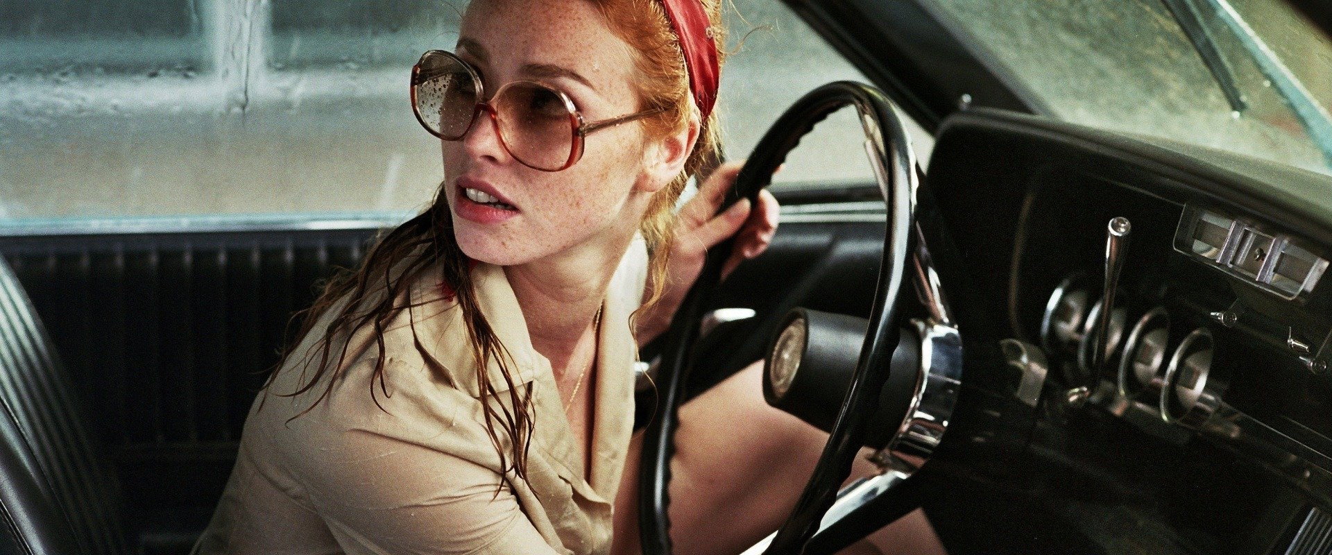 The Lady in the Car with Glasses and a Gun backdrop