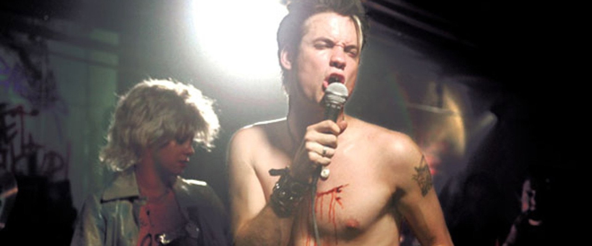 What We Do Is Secret backdrop