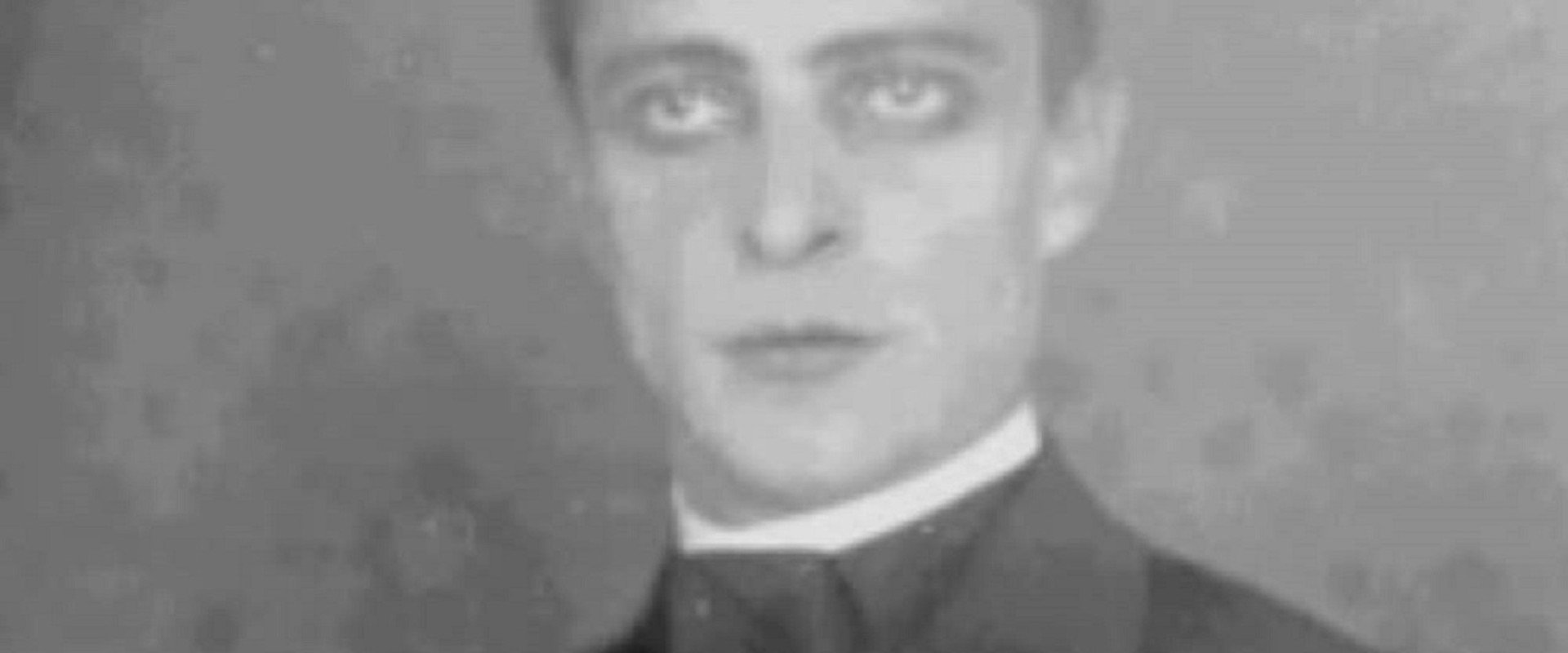 The man in the background's banner image