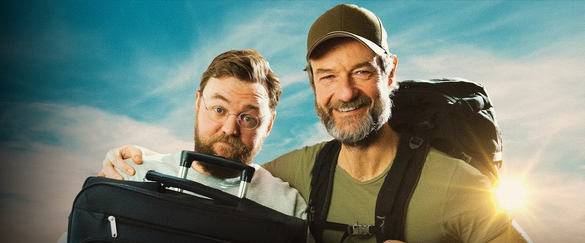 Med rygsæk og rullekuffert