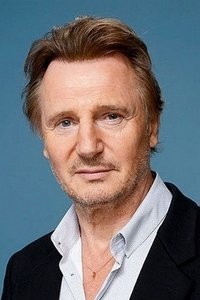 Liam Neeson as Father Liam in Breakfast on Pluto