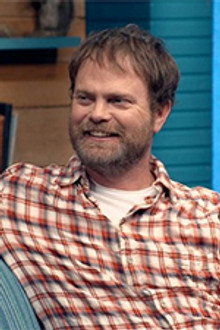 Rainn Wilson Wears a Short Sleeved Plaid Shirt & Colorful Sneakers