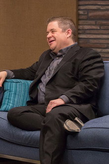 Patton Oswalt Wears a Black Blazer and Dress Shoes