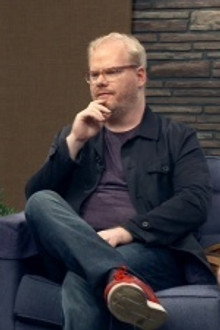 Jim Gaffigan Wears a Blue Jacket & Plum T-Shirt