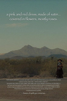 a pink and red dress, made of satin… covered in flowers, mostly roses