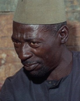 Mustapha Ture as M'barka the Shopkeeper