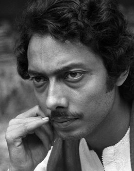 Anjan Dutt as San aka Sandip Banerjee