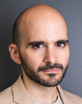 Cyril Aris as Man in Street