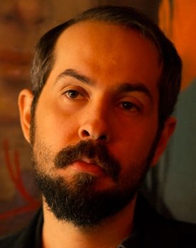 Greg Gonzalez as Fondateur, chant, guitare électrique, guitare acoustique