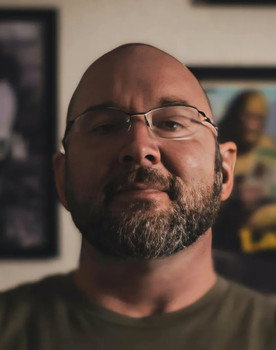 Michael Rock as Tom Compton