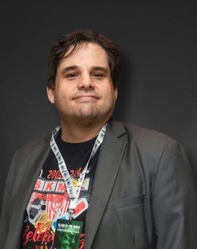 Sean Patrick Kelly as The Voice