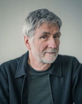 John Walker as Interviewer / Narrator