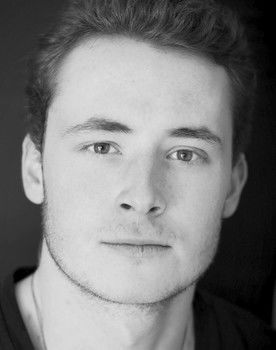 Sam Birch as Suit #2