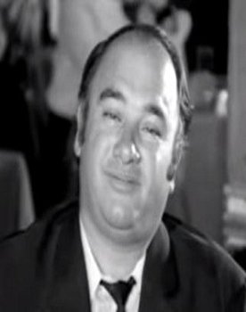 Alekos Zartaloudis as clothing merchant