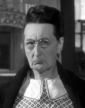 Nora Cecil as Gossip in Ice Cream Parlor / Woman Having Picture Taken