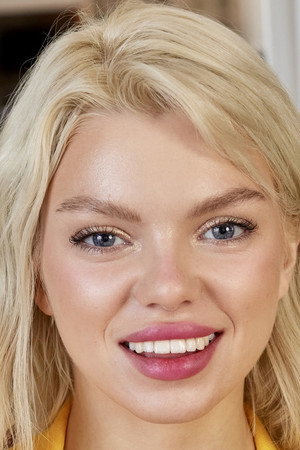 Ashby Winter smiling headshot in yellow top