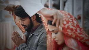 Still from A priest blesses Sneha and Siddhu