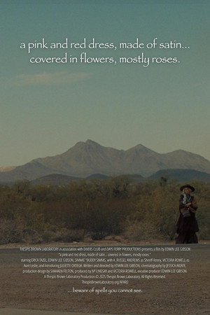 a pink and red dress, made of satin… covered in flowers, mostly roses