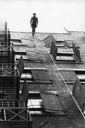 Man Walking Down the Side of a Building Man Walking Down the Side of a Building