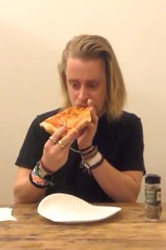 Macaulay Culkin Eating a Slice of Pizza