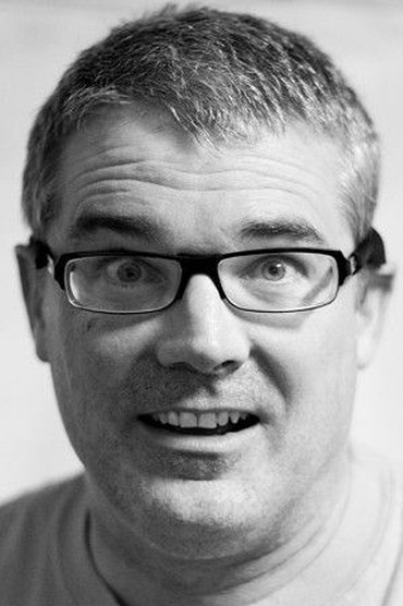 Professional headshot of Milo Aukerman