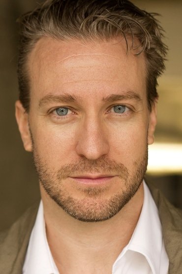Professional headshot of Desmond Devenish