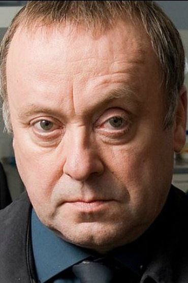Professional headshot of Alex Norton