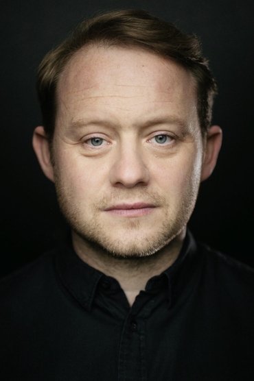 Professional headshot of Michael Jibson