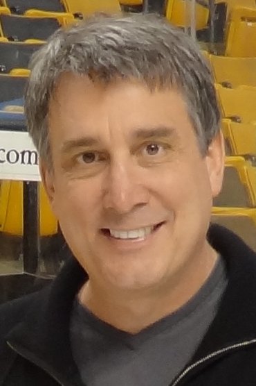 Professional headshot of Cam Neely