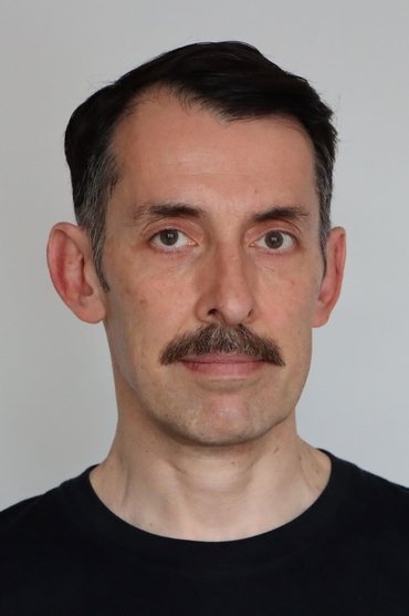 Professional headshot of Denis Michallet