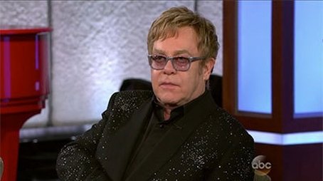 Elton John; Emily VanCamp (2013) - Episode 125 poster and promotional image