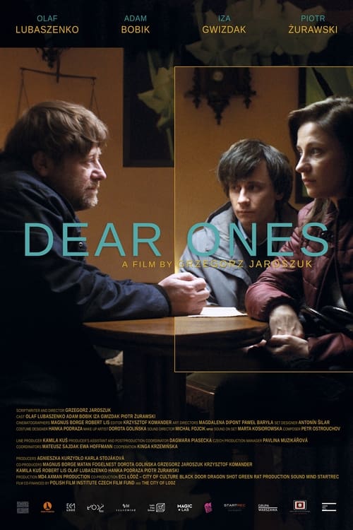 Dear Ones is an allegorical story about people who need to make real contact with their family and friends. Piotr is looking for a purpose and order in his life. To find it, he turns to magic, religion, and psychology. Unexpectedly, his father calls him and asks Piotr to come to his family home immediately. Piotr arrives at the same time with his sister, Marta, whom he hardly remembers and does not recognize. The father called for Piotr and Marta because their Mother went missing. Family members who meet for the first time after many years begin to search together. The facts they discover about their mother make them re-define what kind of family they are.