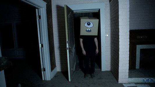 A Ghost and the Boy with a Box on His Head