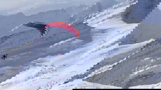 Ueli Steck - Paraglides Between Mountains In The Swiss Alps
