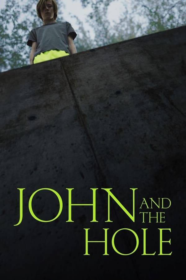 While exploring the neighboring woods, 13-year-old John discovers an unfinished bunker — a deep hole in the ground. Seemingly without provocation, he drugs his affluent parents and older sister and drags their unconscious bodies into the bunker, where he holds them captive. As they anxiously wait for John to free them from the hole, the boy returns home, where he can finally do what he wants.