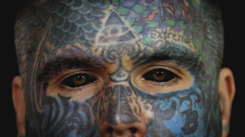 2,000 Tattoos, 40 Piercings, and a Pickled Ear backdrop 1