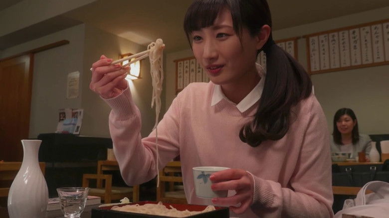 A woman drinking alone at a soba restaurant