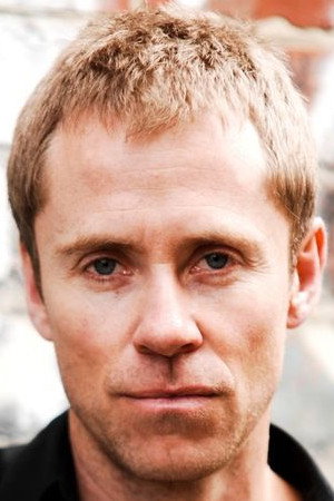 Travis McMahon as Reuben Zeus in Good Guys, Bad Guys