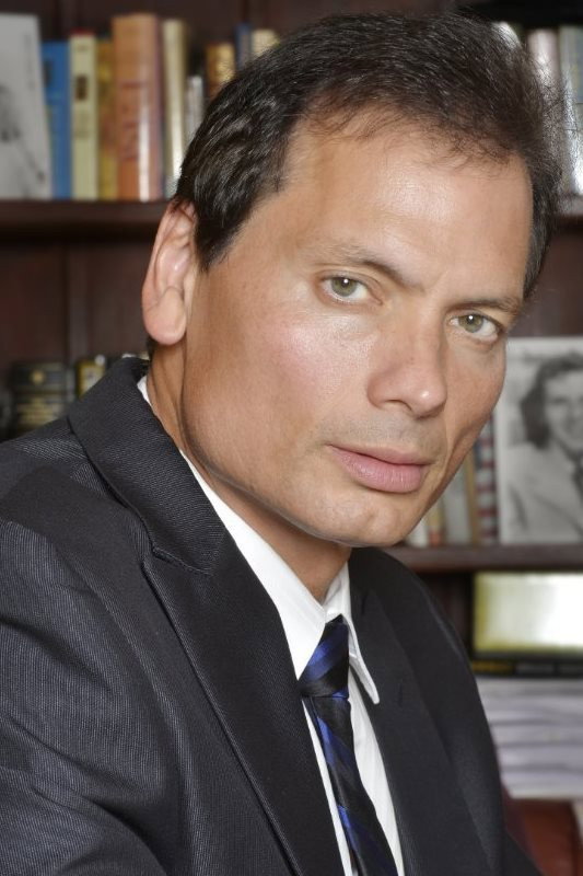 Rico Simonini as Det. Raphael Montoya in Big Bag of $