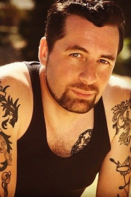 Manuel Caneri as Johnny the Gun in Shit & Champagne