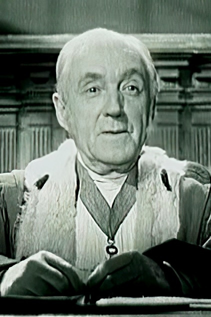 Léon Walther as Maître Denisot, notary in Buzzfeed Unsolved: Supernatural